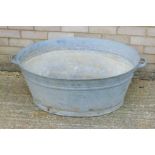 A large galvanized bath. 98 cm wide.