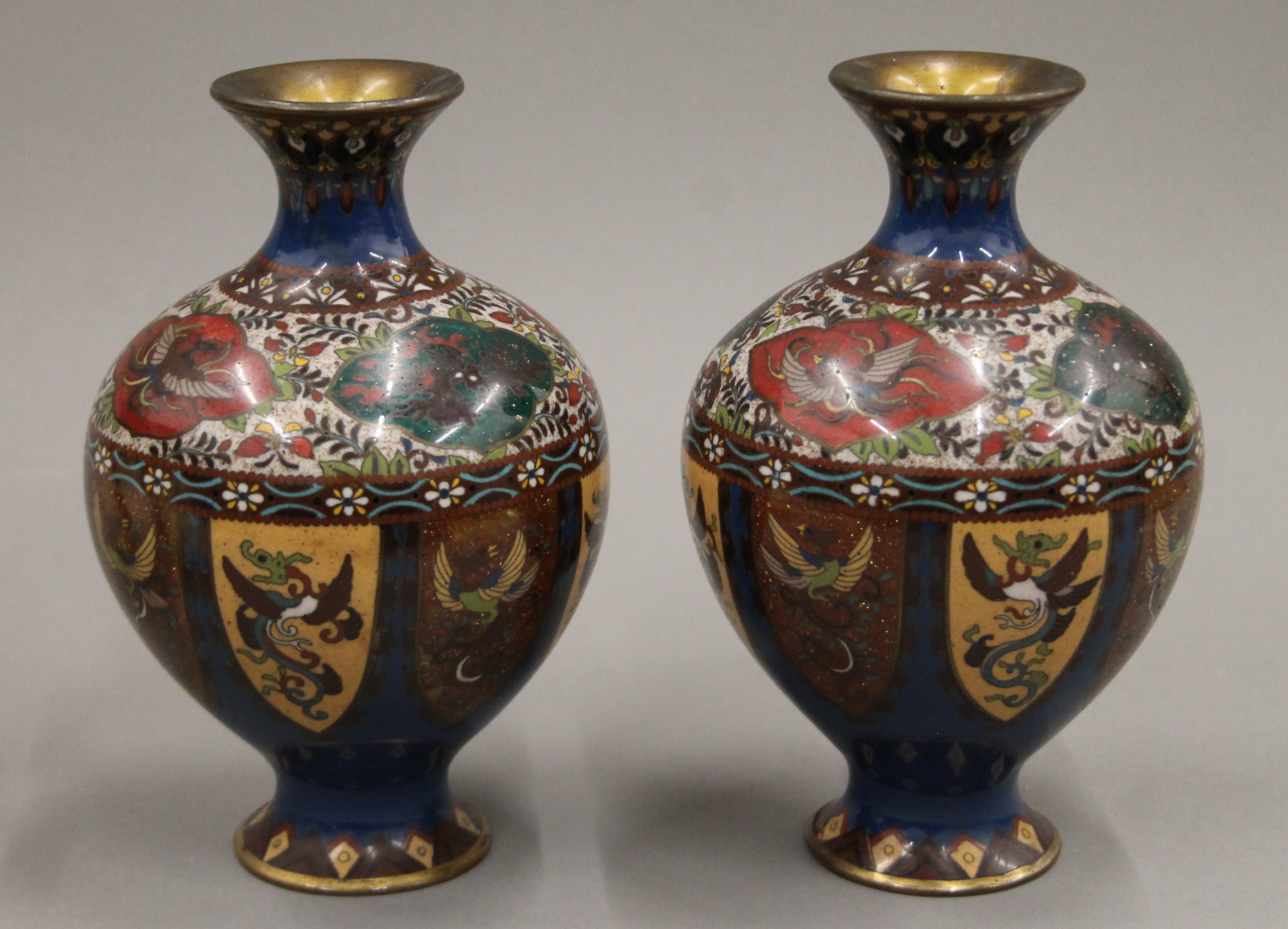 A pair of cloisonne vases. Each 21 cm high.