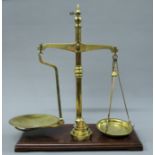A 19th century set of brass scales by Avery and a set of brass weights. 50.5 cm wide.