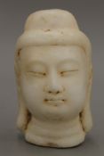 A carved alabaster bust of Buddha. 16 cm high.