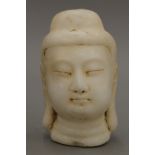 A carved alabaster bust of Buddha. 16 cm high.