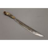 A Middle Eastern hunting knife with horn handle, possibly rhino. 46.5 cm long.