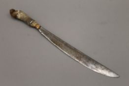 A Middle Eastern hunting knife with horn handle, possibly rhino. 46.5 cm long.