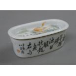 A Chinese Republic Period porcelain pierced lidded box decorated with fish. 13 cm long.