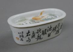 A Chinese Republic Period porcelain pierced lidded box decorated with fish. 13 cm long.