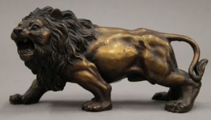 A bronze model of a lion. 17 cm long.