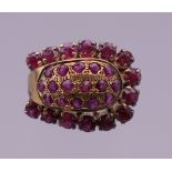 A 14 K gold ruby horseshoe ring. Ring size M. 5.9 grammes total weight.