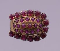 A 14 K gold ruby horseshoe ring. Ring size M. 5.9 grammes total weight.