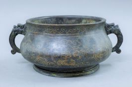 A Chinese bronze censer with silver inlays. 24 cm wide.