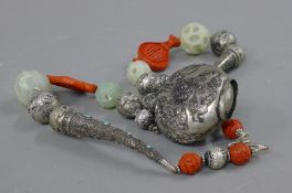 A jade and cinnabar mounted necklace.