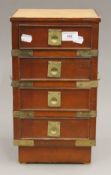 A small leather topped bank of drawers. 38 cm high.