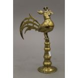 An antique Islamic brass model of a cockerel. 25 cm high.