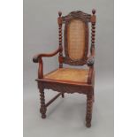 A caned open armchair. 56 cm wide.