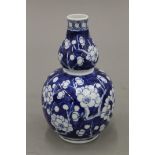 A 19th century Chinese prunus pattern double gourd vase. 18 cm high.