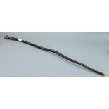 An antique bronze handled African walking staff. 117 cm long.