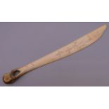 An Inuit bone carving. 24 cm long.