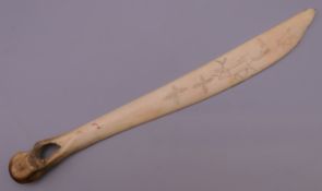 An Inuit bone carving. 24 cm long.