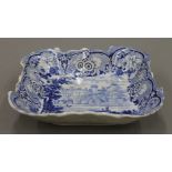 A 19th century blue and white porcelain square dish depicting Warwick Castle. 21.5 cm wide.