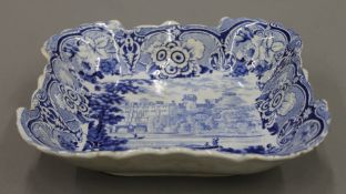 A 19th century blue and white porcelain square dish depicting Warwick Castle. 21.5 cm wide.