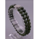 A 14 ct white gold and jade bracelet. 17.5 cm long.