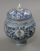 A Chinese blue and white lidded pot decorated with calligraphy. 14 cm high.