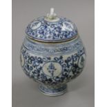 A Chinese blue and white lidded pot decorated with calligraphy. 14 cm high.