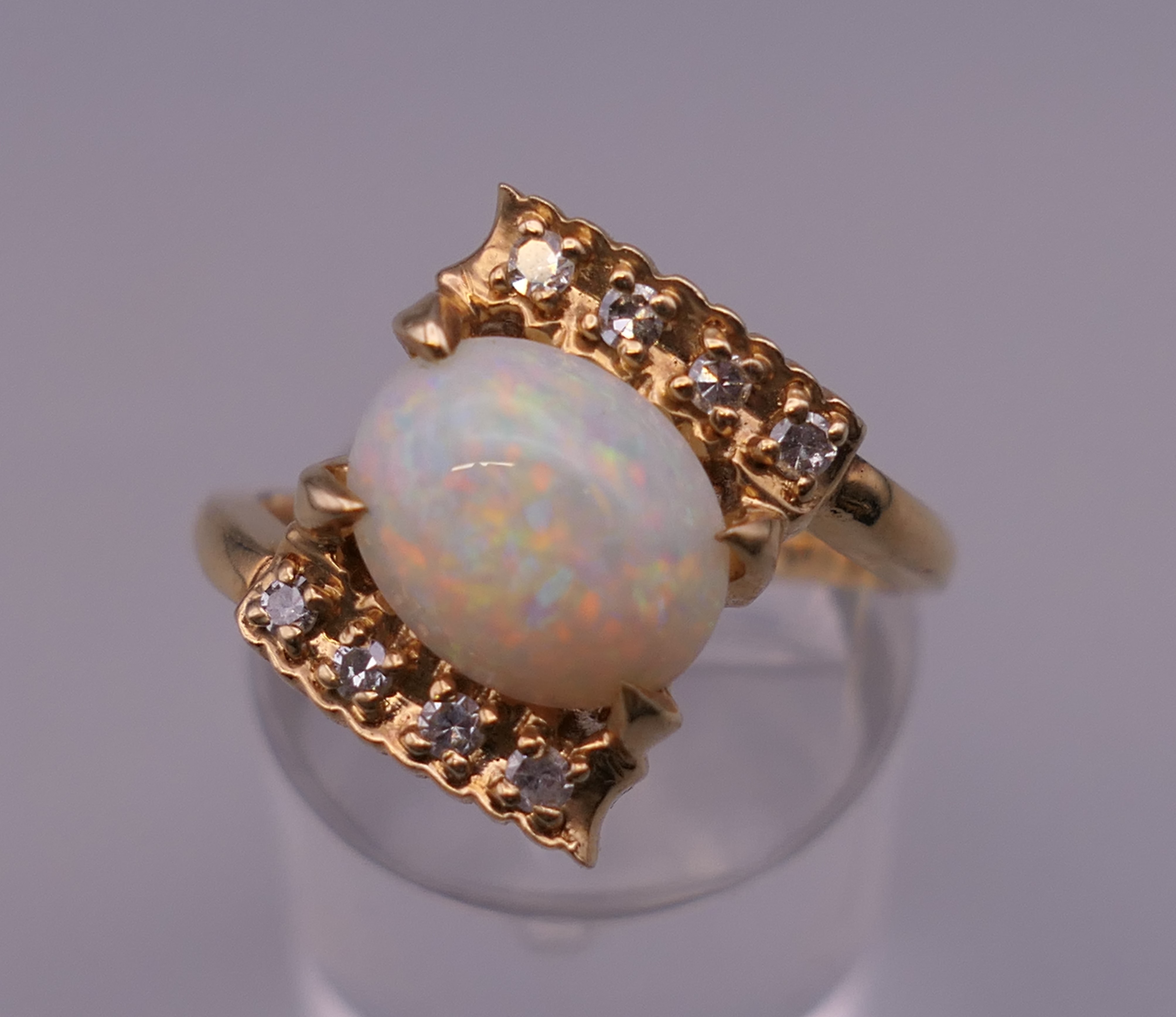 A 14 ct gold opal and diamond ring. Ring N/O. 4.8 grammes total weight.
