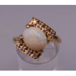 A 14 ct gold opal and diamond ring. Ring N/O. 4.8 grammes total weight.