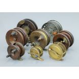 Eight antique fishing reels.