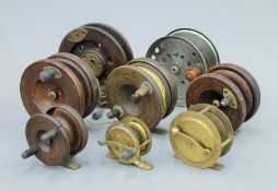 Eight antique fishing reels.