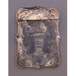 A silver card case. 9 cm high.