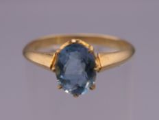 An 18 ct gold aquamarine ring. Ring size L. 2.4 grammes total weight.