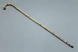 A shark vertebrae and horn walking stick. 90 cm high.