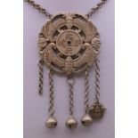A Chinese pendant on chain. The pendant 6 cm wide.
