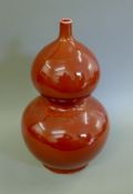 A large Chinese sang de boeuf double gourd vase. 50 cm high.