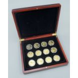 A case of gold plated coins British commemorative.