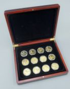 A case of gold plated coins British commemorative.