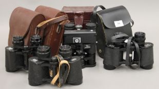 Four cased sets of binoculars.