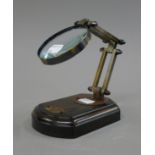 A magnifying glass on stand. Lens 7.5 cm diameter.