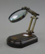 A magnifying glass on stand. Lens 7.5 cm diameter.