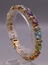 A 14 ct gold multi stone and diamond bracelet. 18.5 cm long. 32.8 grammes total weight.