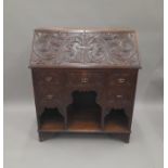 A Victorian carved oak bureau. 90.5 cm wide.