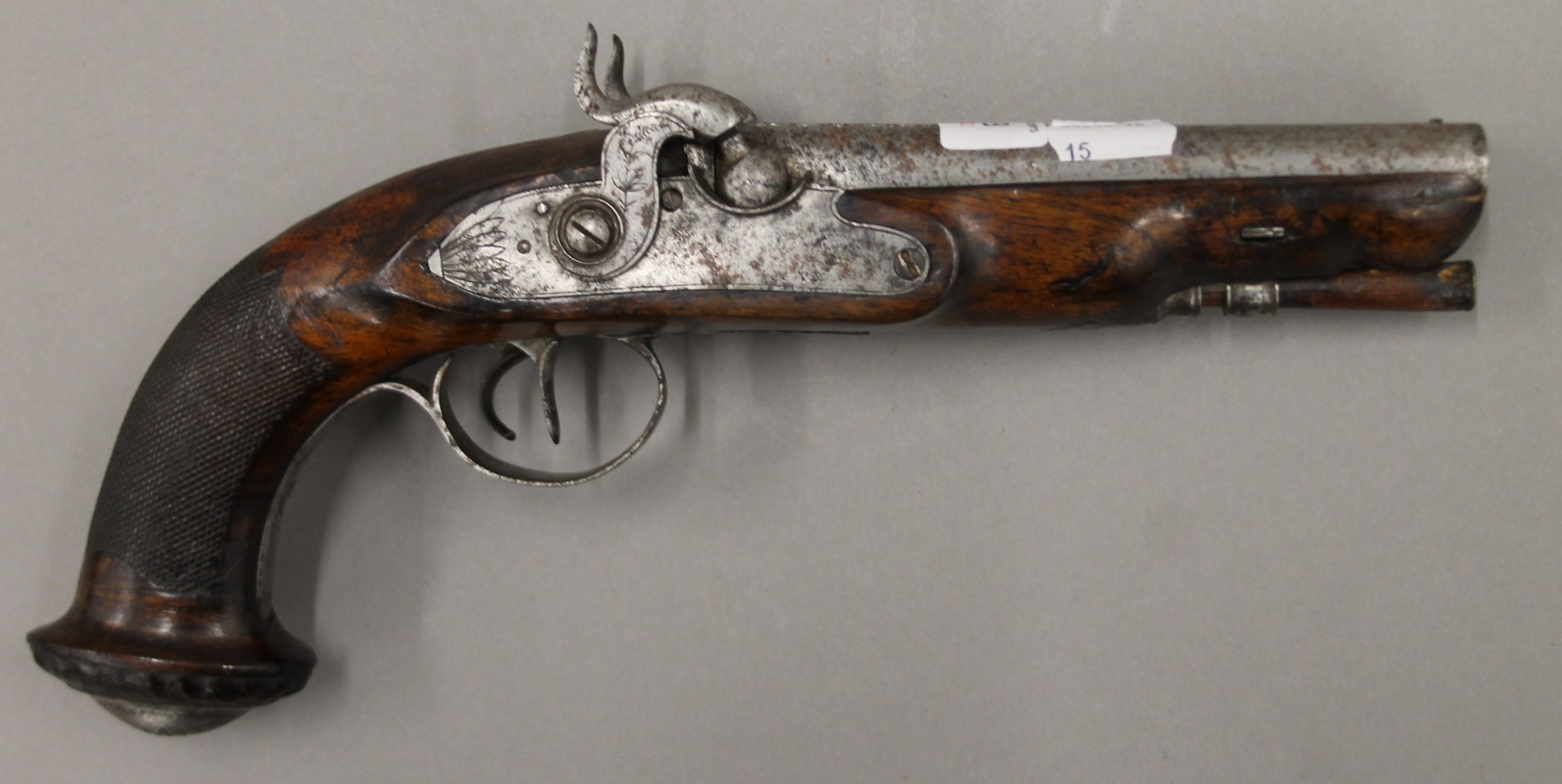 A 19th century double barrel percussion pistol. 31 cm long.