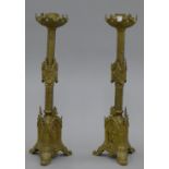A pair of ornate brass altar candlesticks. 56 cm high.