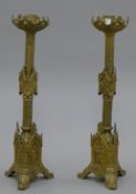 A pair of ornate brass altar candlesticks. 56 cm high.