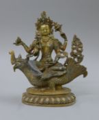 A gilt bronze model of Buddha decorated with coral and turquoise, seated on a mythical beast. 25.