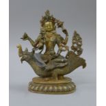 A gilt bronze model of Buddha decorated with coral and turquoise, seated on a mythical beast. 25.