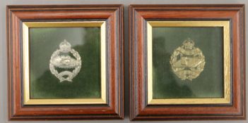 Two WWI English metal Tank Corps cap badges, each framed and glazed. Each 13 x 13 cm overall.