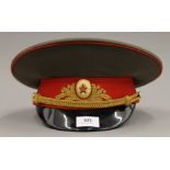 A Russian military interest visor cap with insignia.