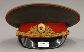 A Russian military interest visor cap with insignia.